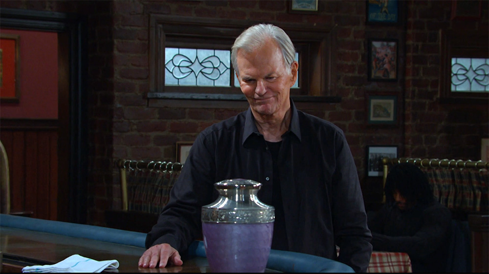 roman brady at the pub with a purple glittered urn with kate's ashes