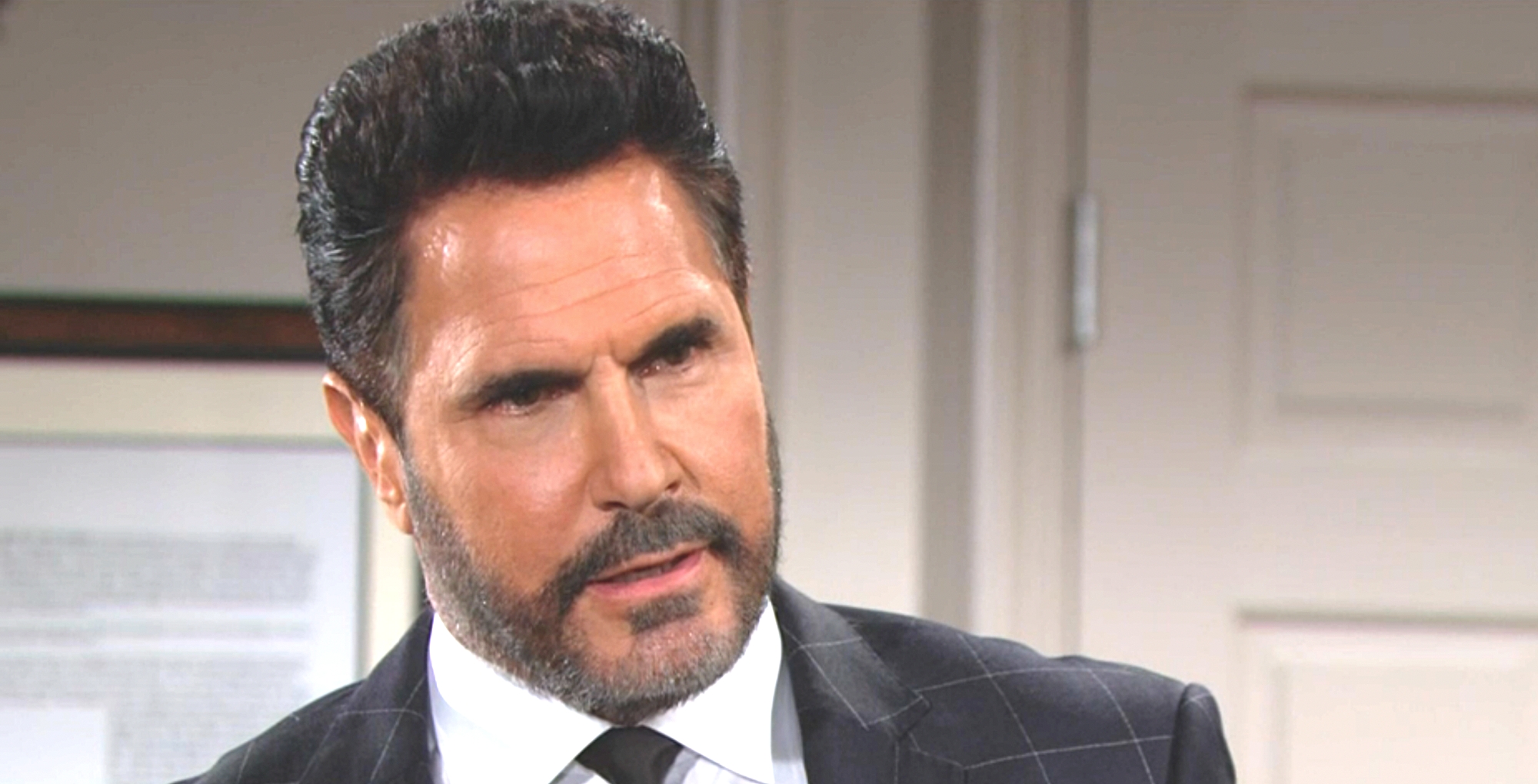 bold and the beautiful spoilers dollar bill spencer in a dark suit, white shirt against a grey wall