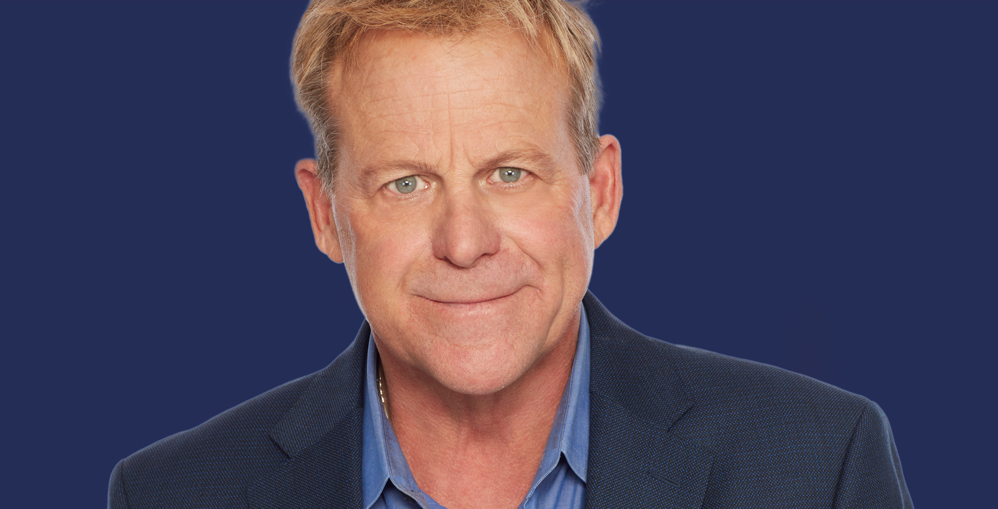 kin shriner from general hospital on a blue background