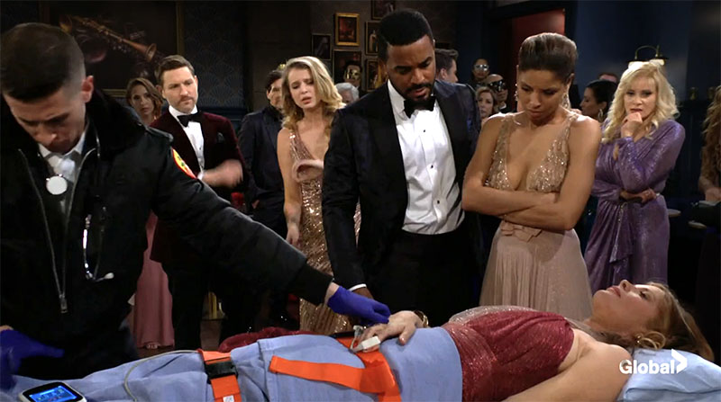 elena and nate look at phyllis as emts prepare to take her away.