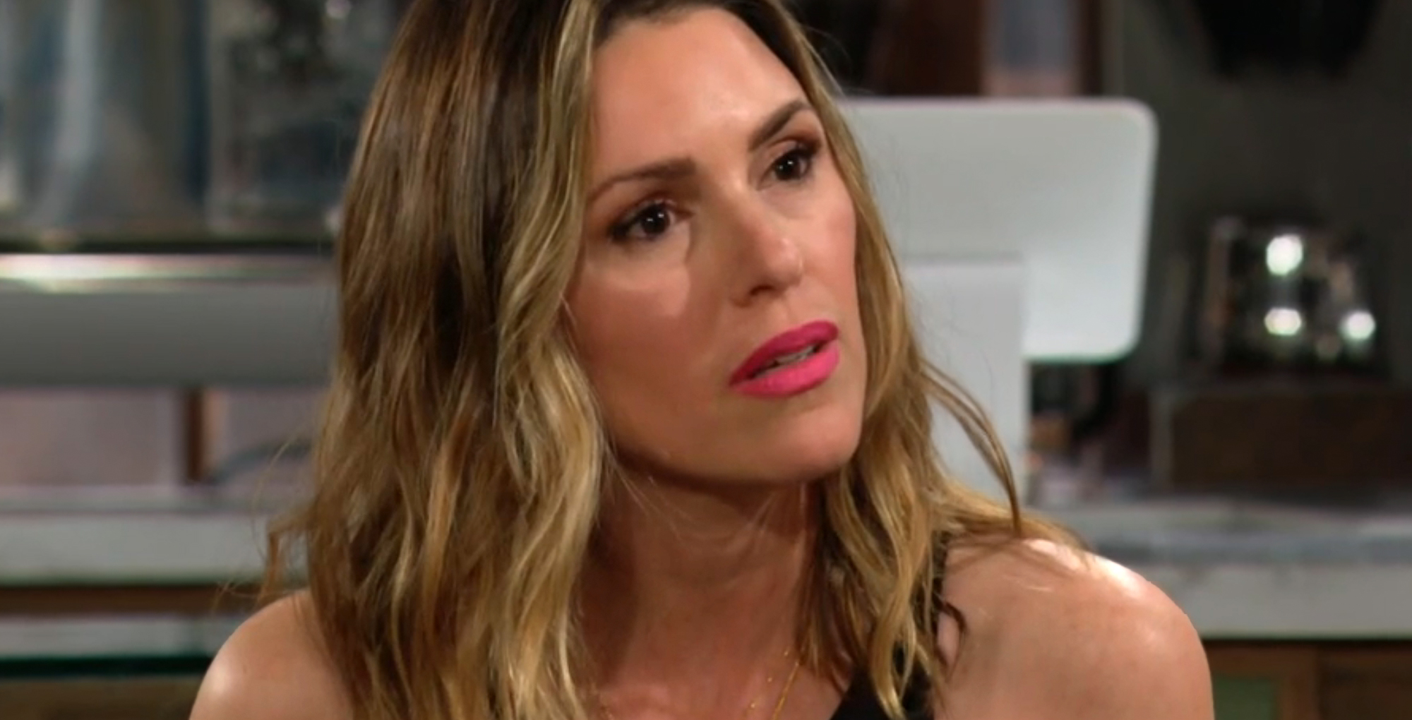 chloe mitchell fisher on the young in the restless sitting in crimson lights.