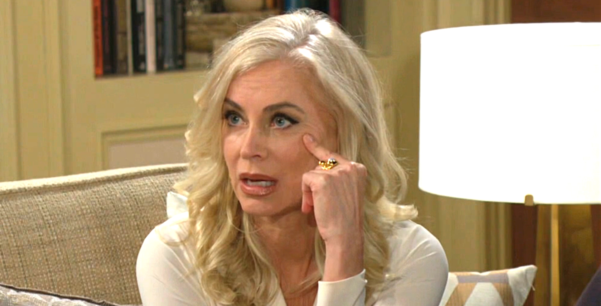 ashley abbott on the young and the restless sitting on a couch.