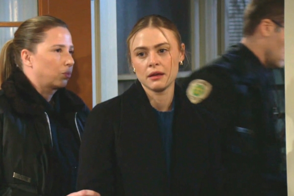 young and the restless a cop leads claire out of the lake house.