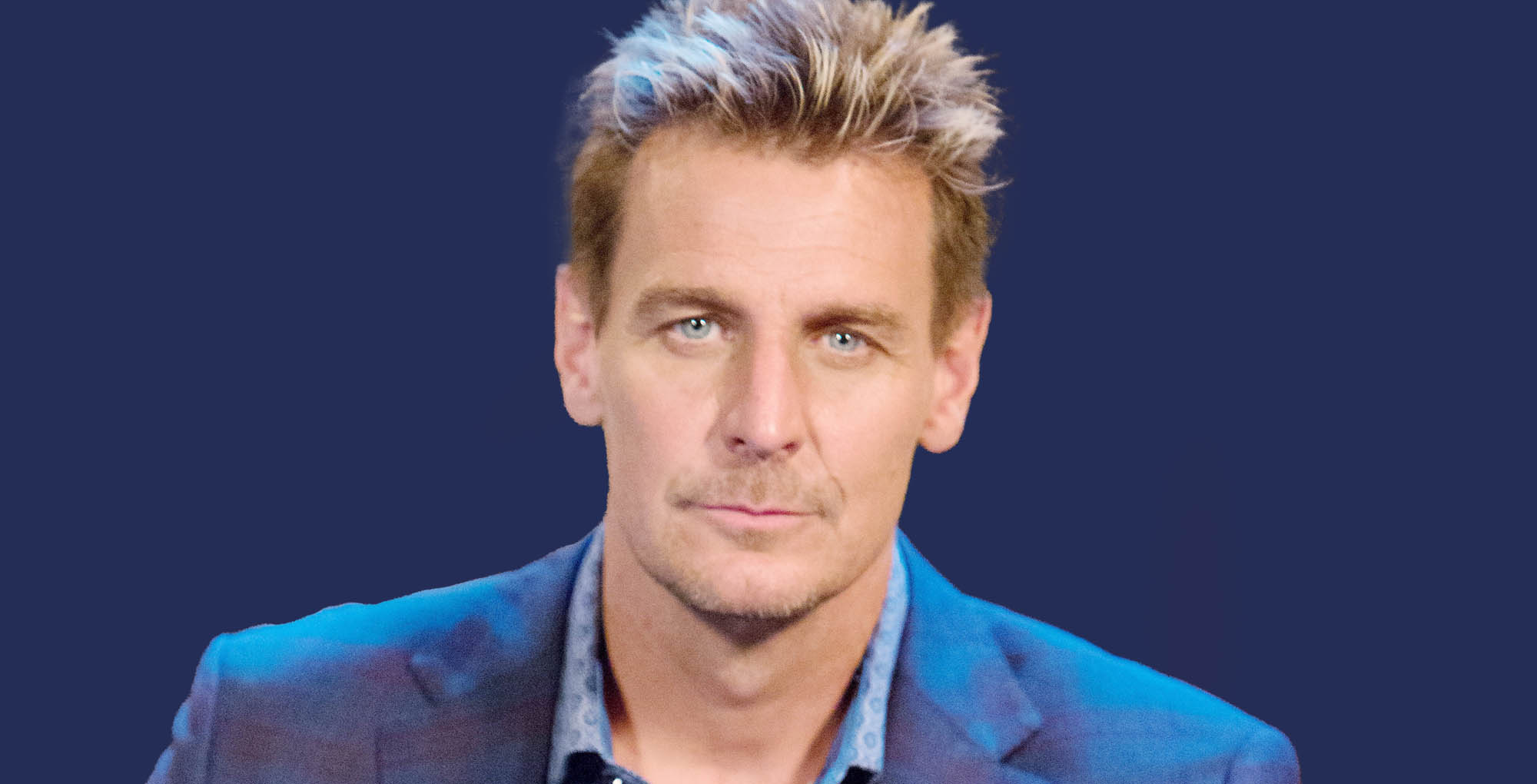 former general hospital actor ingo rademacher against a blue background.